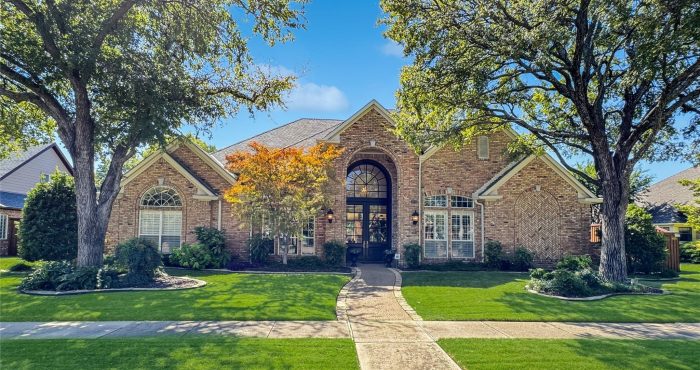 Brick home shaded by mature trees in Whiffletree, Plano, Texas